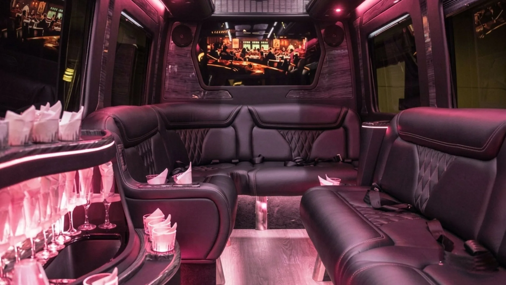 Party bus interior - wraparound lounge seating and LED party lighting